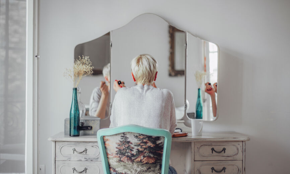 Older woman sitting before a mirror